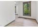 Hallway featuring modern flooring, neutral color paint, natural light, and baseboard trim at 522 Lochness Ln, Cary, NC 27511