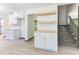 Bright, updated kitchen with white cabinets, wood countertops, and stairs to the second floor at 522 Lochness Ln, Cary, NC 27511