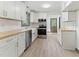 Charming kitchen features stainless steel appliances, white cabinets, butcher block countertops, and modern lighting at 522 Lochness Ln, Cary, NC 27511