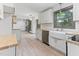 Bright kitchen with white cabinets, butcher block countertops, stainless steel appliances, and a large window at 522 Lochness Ln, Cary, NC 27511