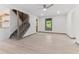 Bright living room with light wood floors, staircase, neutral walls and natural light from a large window at 522 Lochness Ln, Cary, NC 27511