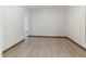 Spacious living room with wood-look flooring, neutral wall colors, and ample natural light at 522 Lochness Ln, Cary, NC 27511