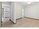 Bright living room with views of the kitchen, wood-look floors, and neutral paint, creating an inviting space at 522 Lochness Ln, Cary, NC 27511