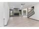 Open-concept living space with a sleek fireplace, modern flooring, stairs and plenty of natural light at 522 Lochness Ln, Cary, NC 27511