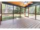 Spacious screened-in porch with wood ceiling, ceiling fan, and backyard view at 522 Lochness Ln, Cary, NC 27511
