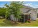 Two-story home's backyard with screened-in porch, mature trees, and well-maintained lawn at 524 Woodson Dr, Clayton, NC 27527