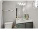 Bright bathroom with a modern vanity, decorative mirror, and updated fixtures at 524 Woodson Dr, Clayton, NC 27527