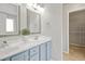 Bright bathroom featuring a double vanity with modern fixtures and a walk-in closet at 524 Woodson Dr, Clayton, NC 27527