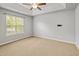 Bedroom featuring a tray ceiling, ceiling fan, carpet flooring, and natural light at 524 Woodson Dr, Clayton, NC 27527