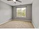 Bedroom with carpet flooring, ceiling fan, and a window that provides natural light at 524 Woodson Dr, Clayton, NC 27527