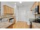 Functional kitchen with stainless steel appliances, light wood cabinets, and hardwood flooring at 524 Woodson Dr, Clayton, NC 27527