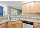 Kitchen sink and countertop featuring stainless steel appliances, and outside view at 524 Woodson Dr, Clayton, NC 27527