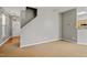 Inviting living room with neutral paint, carpet flooring and staircase access at 524 Woodson Dr, Clayton, NC 27527