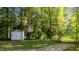 Beautiful wooded backyard featuring a shed and a treehouse at 535 W Holding Ave, Wake Forest, NC 27587