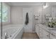 Bathroom featuring soaking tub, double vanity, and tile flooring at 535 W Holding Ave, Wake Forest, NC 27587