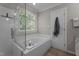 Bathroom featuring soaking tub, walk-in shower, and window at 535 W Holding Ave, Wake Forest, NC 27587
