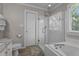 Bathroom with a walk-in shower, soaking tub, and granite vanity at 535 W Holding Ave, Wake Forest, NC 27587