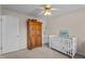 Bedroom featuring a crib, wardrobe, and neutral carpet at 535 W Holding Ave, Wake Forest, NC 27587