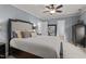 Comfortable bedroom featuring a ceiling fan, neutral carpet, and dark wood furniture at 535 W Holding Ave, Wake Forest, NC 27587