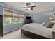 Serene bedroom featuring neutral walls, window blinds, ceiling fan and neutral color bedding at 535 W Holding Ave, Wake Forest, NC 27587