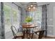 Cozy breakfast nook featuring wood table, decorative lighting, and lots of natural light from surrounding windows at 535 W Holding Ave, Wake Forest, NC 27587