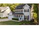 Charming two-story home with black shutters, a covered porch and a manicured front lawn at 535 W Holding Ave, Wake Forest, NC 27587