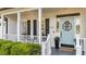Inviting front porch featuring a light blue door with a welcome mat and beautiful flower pot at 535 W Holding Ave, Wake Forest, NC 27587
