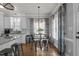 Bright eat in kitchen with white cabinets and a small round table with a decorative chandelier at 535 W Holding Ave, Wake Forest, NC 27587