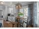 Bright eat in kitchen with white cabinets and a small round table with a decorative chandelier at 535 W Holding Ave, Wake Forest, NC 27587