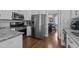 Modern kitchen featuring stainless steel appliances, white cabinets and a view into the dining area at 535 W Holding Ave, Wake Forest, NC 27587