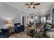 Open-concept living room with hardwood floors, fireplace, and comfortable seating, flowing into the dining area at 535 W Holding Ave, Wake Forest, NC 27587