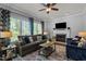 Inviting living room with ceiling fan, fireplace, plush seating, a patterned rug, and ample natural light at 535 W Holding Ave, Wake Forest, NC 27587