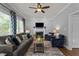 Comfortable living room with neutral walls, fireplace, plush seating, ceiling fan and large windows at 535 W Holding Ave, Wake Forest, NC 27587