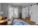 Well-lit home office featuring hardwood floors, a barn door and a window with natural light at 535 W Holding Ave, Wake Forest, NC 27587