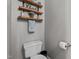 Clean powder room with toilet, shelves, and decorative items creating a simple and functional space at 535 W Holding Ave, Wake Forest, NC 27587