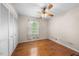 Bedroom with hardwood floors, closet, and a large window providing natural light at 5652 Laurel Crest Dr, Durham, NC 27712