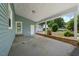 Spacious carport area with a concrete floor, brick foundation, and convenient access to the garage and backyard at 5652 Laurel Crest Dr, Durham, NC 27712
