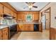 Traditional kitchen equipped with wood cabinets, laminate countertops, and black appliances at 5652 Laurel Crest Dr, Durham, NC 27712
