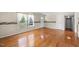 Open living room with hardwood floors, large windows, and border details near the ceiling at 5652 Laurel Crest Dr, Durham, NC 27712