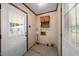 Mud room featuring tiled floors, white doors, and floral wallpaper at 5652 Laurel Crest Dr, Durham, NC 27712