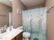 Functional bathroom with a single sink vanity, toilet, and shower featuring an ocean-themed curtain at 70 King Mackeral Ct, Willow Springs, NC 27592