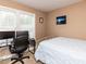 Cozy bedroom with natural light, featuring a desk and a comfortable bed with a seaside-themed painting at 70 King Mackeral Ct, Willow Springs, NC 27592