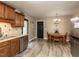 Bright kitchen with granite countertops, stainless steel appliances, and a door to the outside at 70 King Mackeral Ct, Willow Springs, NC 27592
