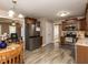 Open kitchen with stainless steel appliances, wood cabinets, and views into the living room at 70 King Mackeral Ct, Willow Springs, NC 27592