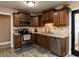 Well-equipped kitchen with stainless steel appliances, wood cabinets, and access to the outside at 70 King Mackeral Ct, Willow Springs, NC 27592