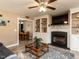 Inviting living room with fireplace, built-in shelving, and views into the dining area at 70 King Mackeral Ct, Willow Springs, NC 27592