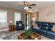 Bright living room with large windows, cozy furniture, and a welcoming atmosphere at 70 King Mackeral Ct, Willow Springs, NC 27592