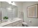 Bright bathroom showcasing a vanity with a white countertop, a framed mirror, and a shower-tub combination at 702 Beacon Hill Rd # 51, Lillington, NC 27546
