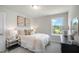Bright, modern bedroom with plush bedding, a large window and stylish decor for comfort at 702 Beacon Hill Rd # 51, Lillington, NC 27546