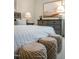 Close-up of a well-decorated bedroom featuring a cozy bed, woven stools, and a stylish dresser with a lamp at 702 Beacon Hill Rd # 51, Lillington, NC 27546